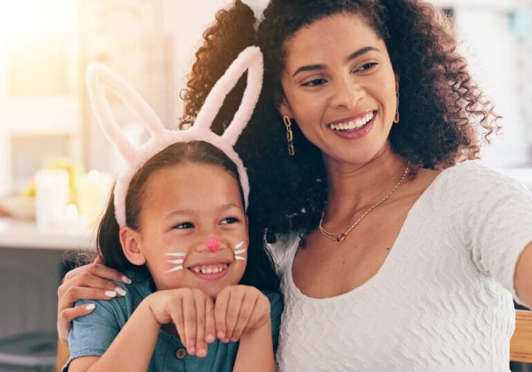 Mother, child and easter in selfie, smile and bunny ears for festive holiday, face paint or post in family home. Mom, kid and rabbit costume with celebration, photography and memory on social network Family celebrating Easter together.