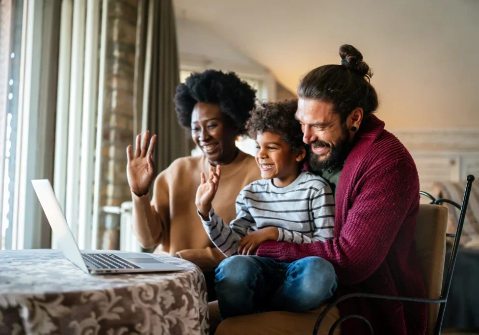 Family video chatting on a laptop.