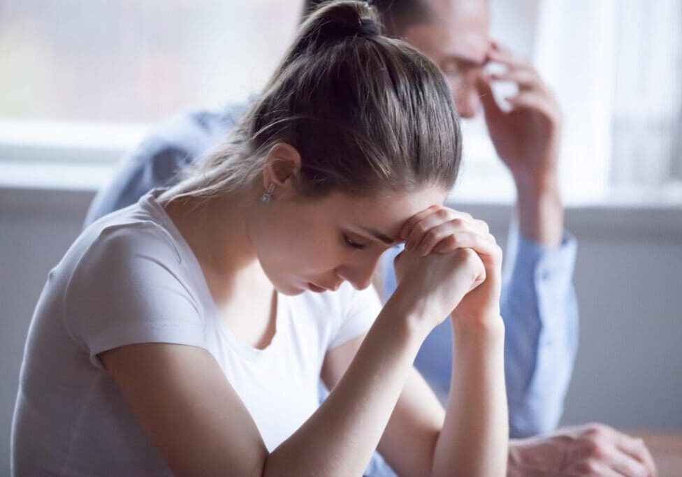 Close up frustrated husband and sad wife on foreground close up. Silent married couple after quarreling thinking about their relationships. Break up difficulties between spouses and divorce concept